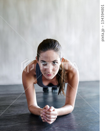 Gym floor, portrait and woman focus on plank exercise, health motivation or core muscle building. Balance challenge, hard work mindset and person doing body development workout in fitness studio Gym floor, portrait and woman focus on plank exercise, health motivation or core muscle building. Balance challenge, hard work mindset and person doing body development workout in fitness studio 134394801