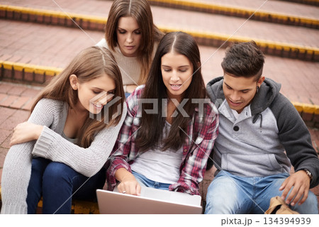 University, laptop and friends on campus stairs in conversation, learning and discussion for group project. Diversity, education and men and women students on computer for school, academy and college 134394939