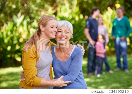 Family, mother and adult daughter hug in park, spending quality time in outdoor together with happiness and care. Happy women are content in relationship with love, bonding and carefree in nature 134395210