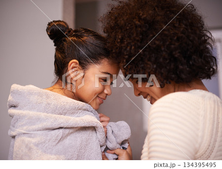 Mother, child in bath towel and close for love, bonding and hugging after cleaning, shower and routine in a bathroom. Washing, embrace and mom with girl, loving and care after a bath in their home 134395495