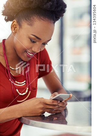 Phone, smile and black woman texting at table, online browsing or internet in restaurant. Cellphone, happy and African female person networking, social media and web scrolling on mobile technology. 134395604