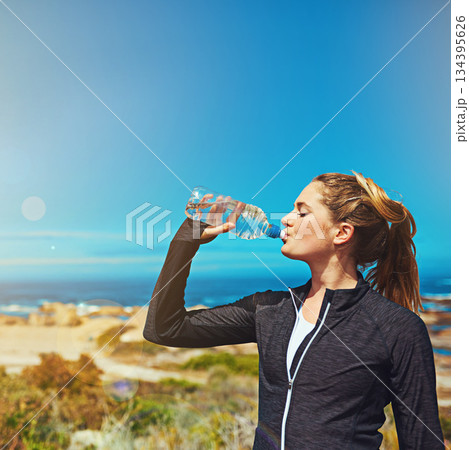 Woman drink water, health and fitness with blue sky, athlete outdoor with hydration and mockup space. Exercise at beach, female person drinking h2o from bottle with workout and break from training Woman drink water, health and fitness with blue sky, athlete outdoor with hydration and mockup space. Exercise at beach, female person drinking h2o from bottle with workout and break from training 134395626