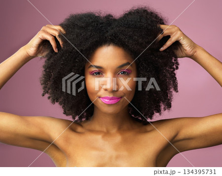 Face, hair care and black woman with afro in studio isolated on a pink background with eyeshadow. Hairstyle portrait, lipstick makeup and African female model with salon treatment for cosmetics. Face, hair care and black woman with afro in studio isolated on a pink background with eyeshadow. Hairstyle portrait, lipstick makeup and African female model with salon treatment for cosmetics. 134395731