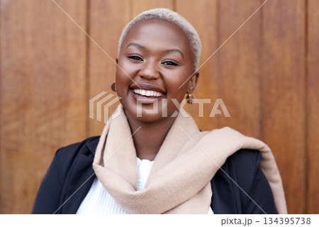 Face, fashion and portrait of a happy black woman with a smile, happiness and positive mindset. Headshot of female model person with beauty laughing against a wooden wall in city for business travel Face, fashion and portrait of a happy black woman with a smile, happiness and positive mindset. Headshot of female model person with beauty laughing against a wooden wall in city for business travel 134395738