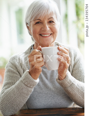 Portrait, happy old woman and cup of coffee in home for break, relaxing morning and retirement. Face, smile and senior lady drinking mug of warm beverage, tea time and happiness of good mood in house 134395764