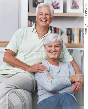 Senior couple, portrait and smile in living room for love, care and quality time together at home. Face of happy elderly man, old woman and enjoy retirement, support and relax in relationship 134395784