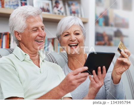Excited senior couple, tablet and credit card for online shopping on living room sofa together at home. Happy elderly man and woman smiling on technology in ecommerce, sale or payment on lounge couch Excited senior couple, tablet and credit card for online shopping on living room sofa together at home. Happy elderly man and woman smiling on technology in ecommerce, sale or payment on lounge couch 134395794