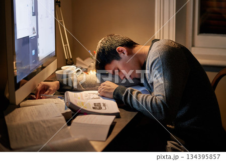 Young student, books and sleeping near screen or studying late into the night or resting on table and reading for examination. Tired, research and hard working for test paper or computer at home 134395857