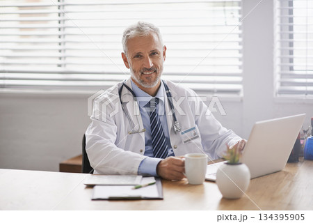 Healthcare, laptop and portrait of male doctor in his office analyzing online test results in a hospital. Happy, smile and professional mature man or medical worker working on a computer in a clinic 134395905