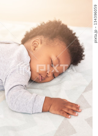 Comfort, bed and baby sleeping in home on blanket for rest, nap time and dreaming in nursery. Childcare, newborn and cute, tired and African child in bedroom sleep for comfortable, relaxing and calm Comfort, bed and baby sleeping in home on blanket for rest, nap time and dreaming in nursery. Childcare, newborn and cute, tired and African child in bedroom sleep for comfortable, relaxing and calm 134396059