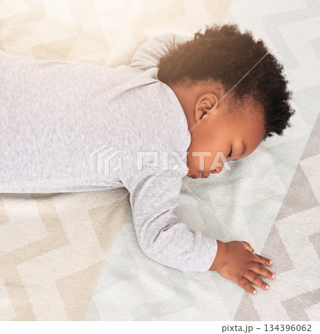 Baby, african boy and sleeping in bedroom for rest, health and peace for growth, development and relax in family home. Black male infant, tired and sleep on bed with fatigue, quiet and calm in house 134396062