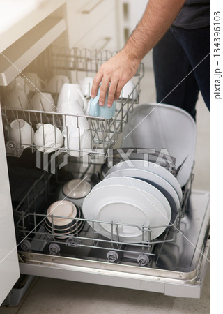 Cleaning, loading dishwasher and hands with dishes in the kitchen for housework and responsibility. Lifestyle, morning and a person doing housekeeping, organizing crockery and clean equipment Cleaning, loading dishwasher and hands with dishes in the kitchen for housework and responsibility. Lifestyle, morning and a person doing housekeeping, organizing crockery and clean equipment 134396103