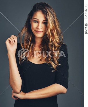 Portrait, face and fashion of woman in studio with natural beauty, hair care and aesthetic makeup on background. Beautiful female model with confidence, casual style and curly hairstyle on backdrop 134396110