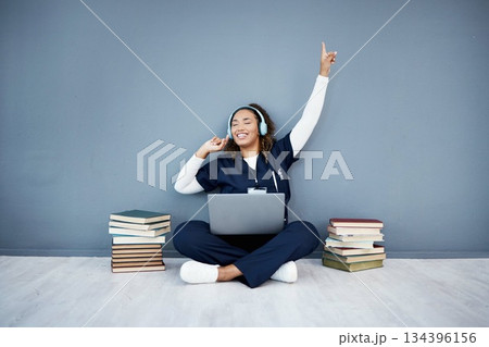 Doctor, laptop or headphones dance to hospital music, podcast or radio in woman study research or mock up learning. Smile, happy or dancing medical student on healthcare technology for books success 134396156