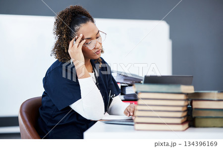 Medical student, tired or stress in hospital research, wellness books studying or education technology learning. Thinking woman, burnout or healthcare nurse anxiety in scholarship medicine internship 134396169
