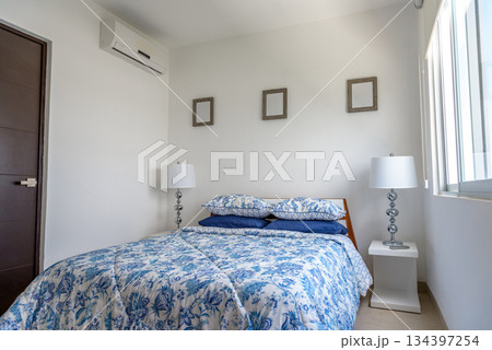 Cozy Bedroom with Soft Lighting and Blue Bedding Cozy Bedroom with Soft Lighting and Blue Bedding 134397254