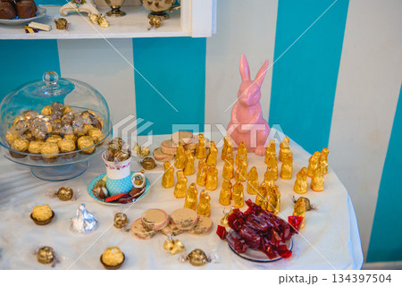Easter chocolate display with gold wrappers and pink bunny 134397504