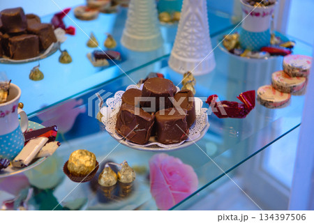 vintage dessert table with cookies chocolates and pink roses 134397506