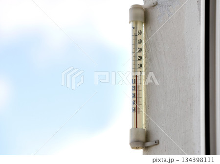 Alcohol glass thermometer Celsius outside on bright blurred light outdoors copy space background. Alcohol glass thermometer Celsius outside on bright blurred light outdoors copy space background. 134398111