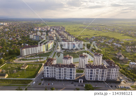 Top view of urban developing city landscape with tall apartment buildings and suburb houses. Drone aerial photography. 134398121