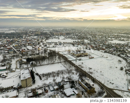 Top view of city suburbs or small town nice houses on winter morning on cloudy sky background. Aerial drone photography concept. 134398139