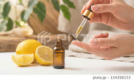 woman applying serum vitamin c on her skin face 134398153