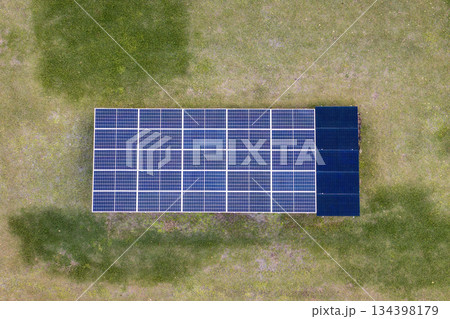 Solar photovoltaic panels mounted on stand-alone frame on backyard ground for generating of clean ecological electric energy Solar photovoltaic panels mounted on stand-alone frame on backyard ground for generating of clean ecological electric energy 134398179