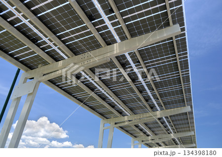 Solar panels installed over parking lot canopy shade for parked cars for effective generation of clean energy Solar panels installed over parking lot canopy shade for parked cars for effective generation of clean energy 134398180