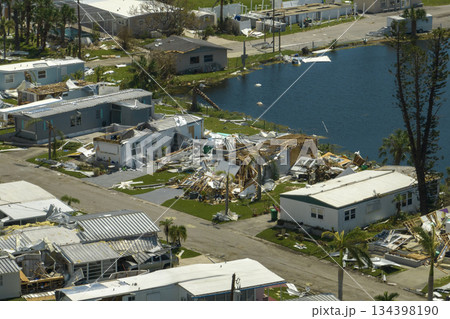 Severely damaged houses after hurricane Ian in Florida mobile home residential area. Consequences of natural disaster Severely damaged houses after hurricane Ian in Florida mobile home residential area. Consequences of natural disaster 134398190