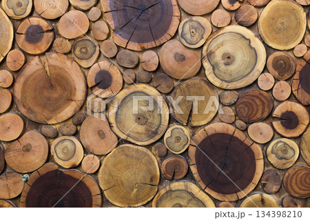 Round wooden unpainted solid natural ecological soft colored brown and yellow stumps background, Tree cut sections different sizes for pad mat background texture. Do It Yourself art concept. 134398210