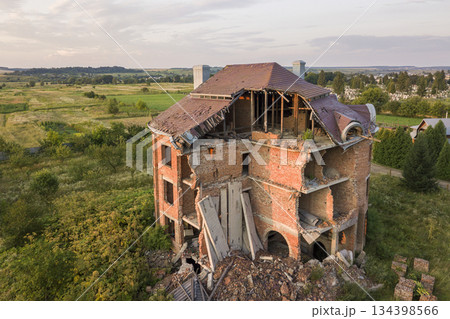 Old ruined building after earthquake. A collapsed brick house . 134398566