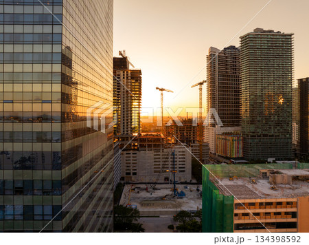 New construction site in Miami, Florida au sunset. Developing residence in American urban area. Concept of housing growth in the USA New construction site in Miami, Florida au sunset. Developing residence in American urban area. Concept of housing growth in the USA 134398592