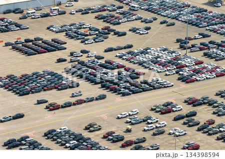 New cars parked for sale on automotive factory parking lot. Dealer vehicle inventory for import and export business commercial worldwide New cars parked for sale on automotive factory parking lot. Dealer vehicle inventory for import and export business commercial worldwide 134398594