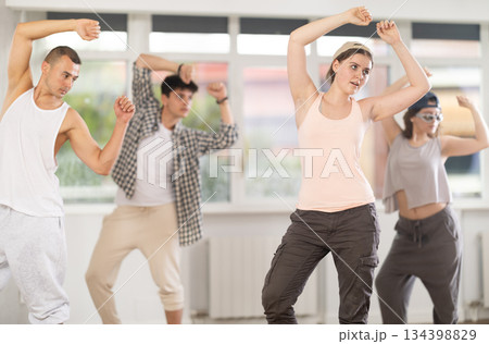 Young girl practicing basic hip hop moves in training hall 134398829