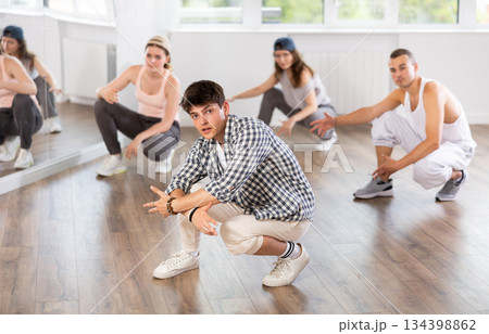 Break dance performed by a group of young dancers in dance studio 134398862