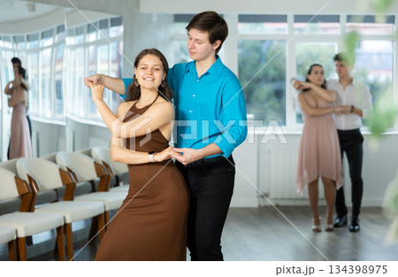 During rehearsal, guy and girl participants of dance workshop perform social pair dance 134398975