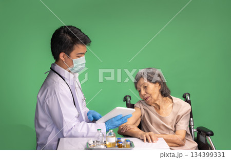 Chroma key, nurse doing vaccine injection to senior woman. 134399331