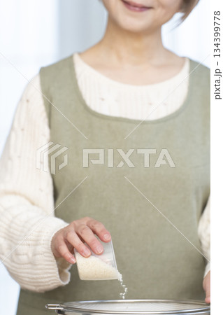 キッチンでご飯を炊く準備をするシニア女性の手元 134399778