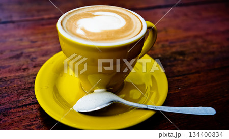 close up photo of a cup of coffee on a brown table close up photo of a cup of coffee on a brown table 134400834