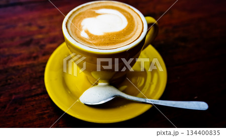 close up photo of a cup of coffee on a brown table close up photo of a cup of coffee on a brown table 134400835