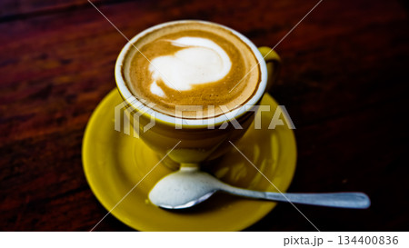 close up photo of a cup of coffee on a brown table 134400836