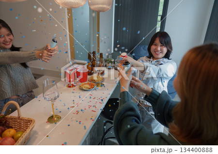 Party Fun. Friends celebrating with confetti and drinks at a lively gathering. Party Fun. Friends celebrating with confetti and drinks at a lively gathering. 134400888