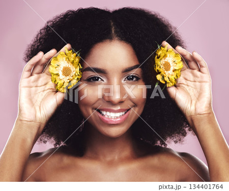 Happy woman, hair and daisy flowers in studio, pink background and floral aesthetic of natural beauty. Portrait, face and african model with yellow plants, afro and smile for vegan cosmetic skincare Happy woman, hair and daisy flowers in studio, pink background and floral aesthetic of natural beauty. Portrait, face and african model with yellow plants, afro and smile for vegan cosmetic skincare 134401764