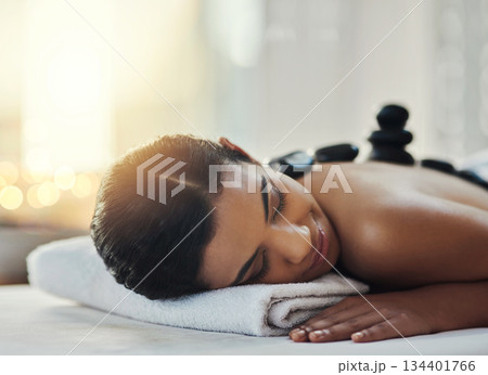 Happy woman, relax and sleeping in massage at spa for skincare, beauty or body treatment. Calm female asleep in relaxation with hot rocks or pile on back in therapy, zen or wellness at salon resort Happy woman, relax and sleeping in massage at spa for skincare, beauty or body treatment. Calm female asleep in relaxation with hot rocks or pile on back in therapy, zen or wellness at salon resort 134401766