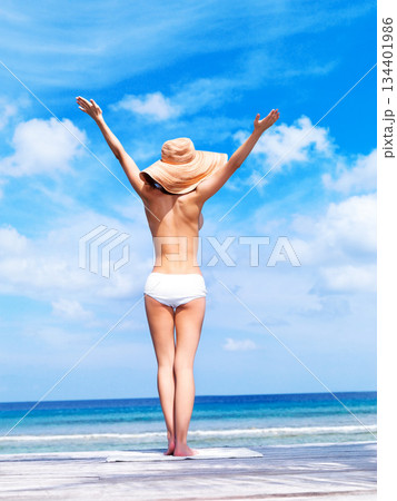 Travel, relax and topless with woman at beach for sunbathing, summer break and freedom in Bali. Sexy, blue sky and tropical with girl in bikini on vacation for confident, peace and beauty on trip Travel, relax and topless with woman at beach for sunbathing, summer break and freedom in Bali. Sexy, blue sky and tropical with girl in bikini on vacation for confident, peace and beauty on trip 134401986