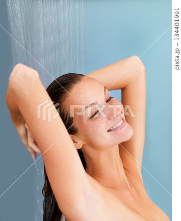 Smile, skincare and happy with woman in shower for bathroom, hygiene and luxury. Wellness, spa and washing hair with face of girl for facial, cleaning and hydration isolated on blue background studio Smile, skincare and happy with woman in shower for bathroom, hygiene and luxury. Wellness, spa and washing hair with face of girl for facial, cleaning and hydration isolated on blue background studio 134401991