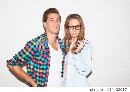 Party portrait of hipster couple smoking with glasses, gen z fashion and university culture in youth. Cigarettes, woman and man at fun college event, cool people on white wall background with smoke. Party portrait of hipster couple smoking with glasses, gen z fashion and university culture in youth. Cigarettes, woman and man at fun college event, cool people on white wall background with smoke. 134402017