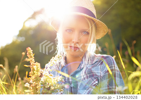Lens flare, countryside and portrait of woman with sun in field for freedom, wellness and relax. Nature, hipster and face of female person in flower meadow for sustainability and ecology in summer Lens flare, countryside and portrait of woman with sun in field for freedom, wellness and relax. Nature, hipster and face of female person in flower meadow for sustainability and ecology in summer 134402028