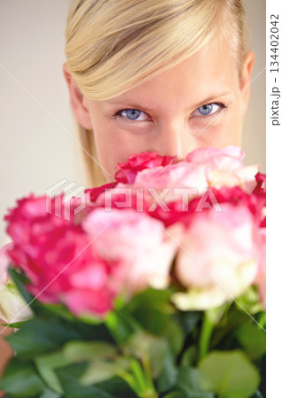 Roses, bouquet and portrait of woman in studio for valentines day, gift or thank you gesture on grey background. Face, rose and girl with flowers, happy and relax with floral arrangement on mockup 134402042
