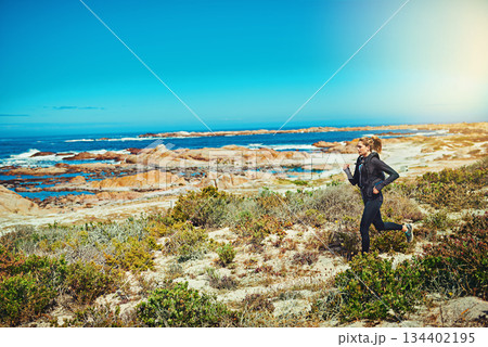 Woman running, beach and fitness outdoor with cardio and training for marathon with young athlete and sports. Female runner in nature, ocean and run for exercise with healthy person and mockup space Woman running, beach and fitness outdoor with cardio and training for marathon with young athlete and sports. Female runner in nature, ocean and run for exercise with healthy person and mockup space 134402195